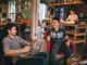 photograph of men having conversation seating on chair