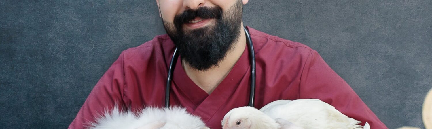 a man in red shirt holding a cat and a chicken