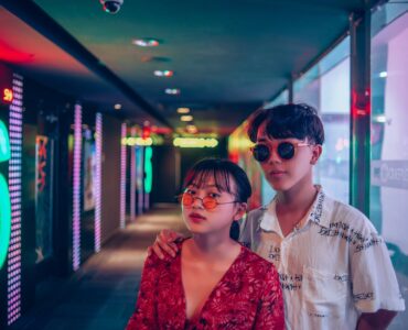 two man and woman wearing sunglasses inside building