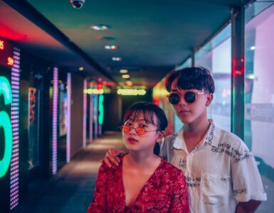 two man and woman wearing sunglasses inside building