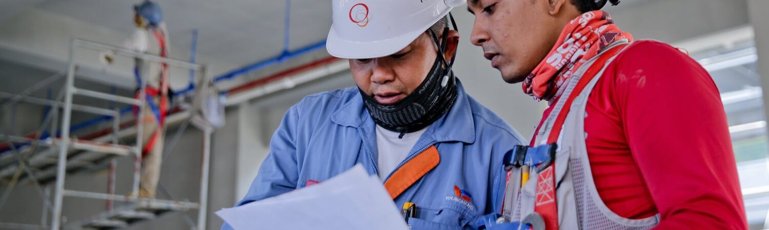 two man holding white paper