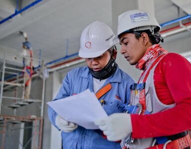 two man holding white paper