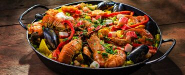 paella served with shrimp in wok