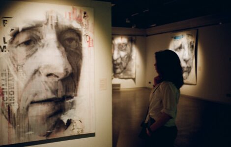 woman standing in front of man s painting