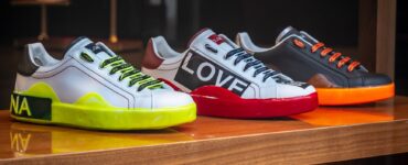 three unpaired multicolored leather sneakers on display