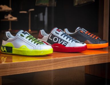 three unpaired multicolored leather sneakers on display