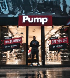 man standing at the doorway of pump shop