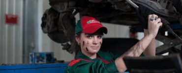 woman holding gray steel wrench