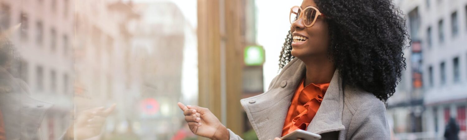 happy black woman laughing on street