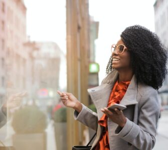 happy black woman laughing on street