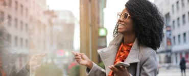 happy black woman laughing on street