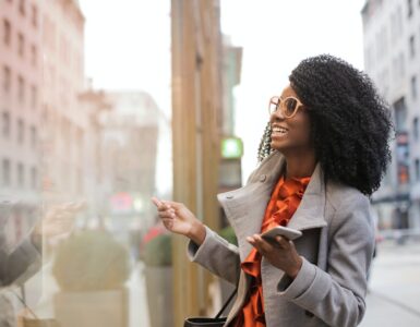 happy black woman laughing on street