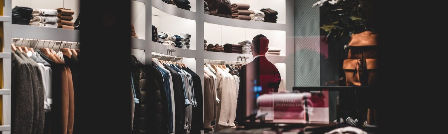 anonymous stylish man during shopping in fashion store