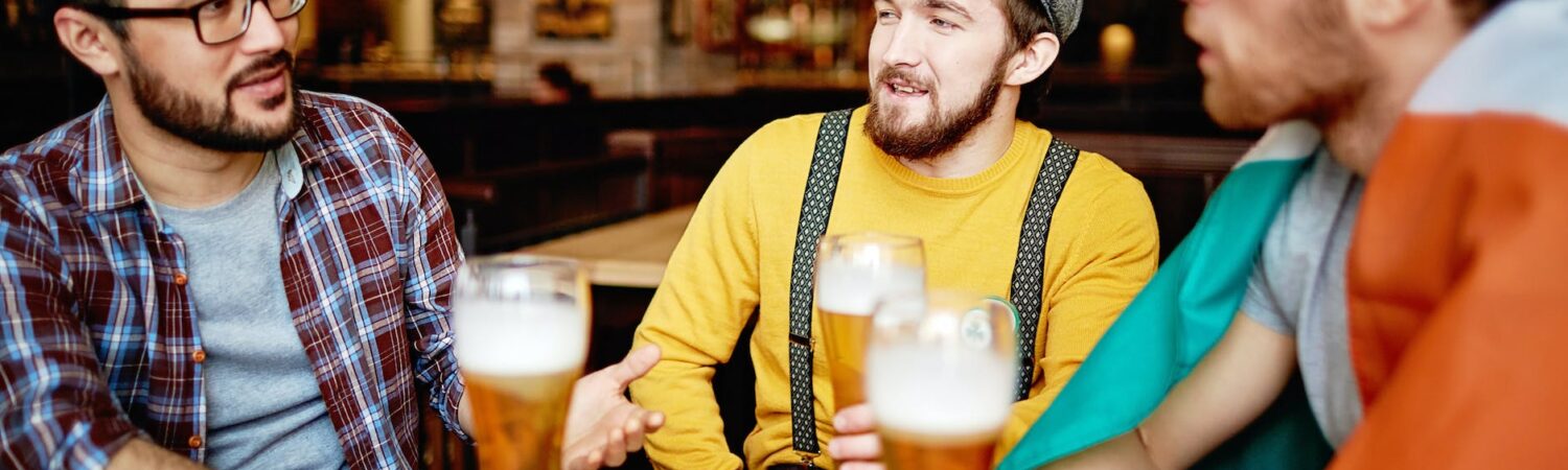 men talking at a bar