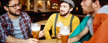 men talking at a bar