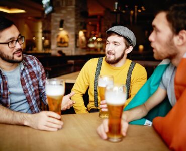 men talking at a bar