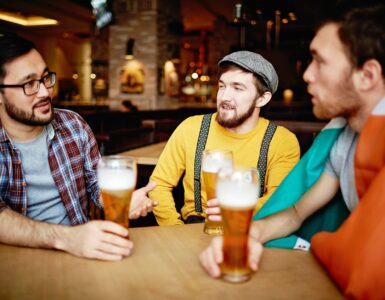 men talking at a bar