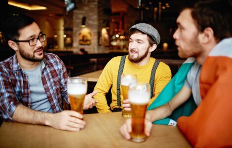 men talking at a bar