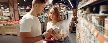 young couple selecting food in market