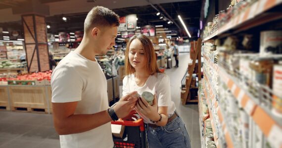 young couple selecting food in market