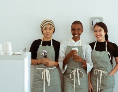 delighted baristas with portafilter and paper cup