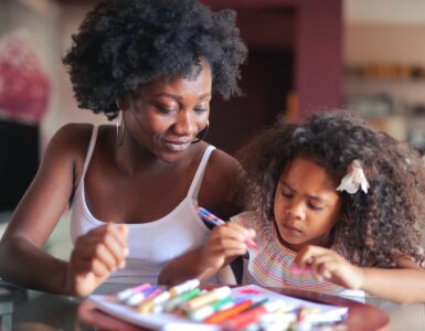 mother sitting next to her daughter