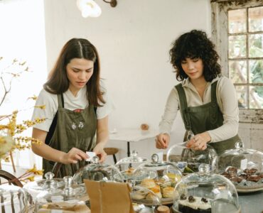 pensive waitress in apron serving table