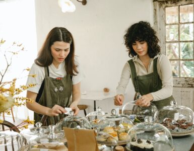 pensive waitress in apron serving table