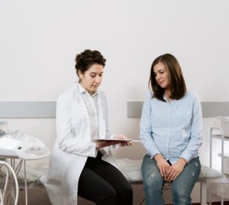 photo of pregnant woman having a consultation