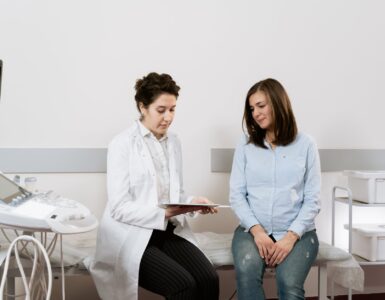 photo of pregnant woman having a consultation