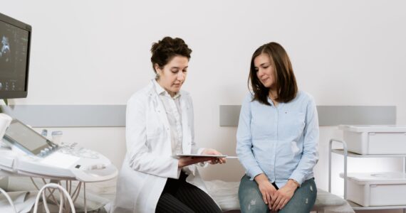 photo of pregnant woman having a consultation