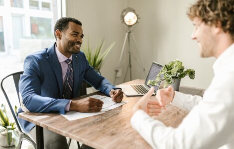 men sitting at table smiling