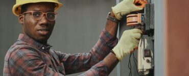 an electrician repairing a fuse box