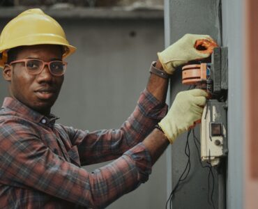 an electrician repairing a fuse box