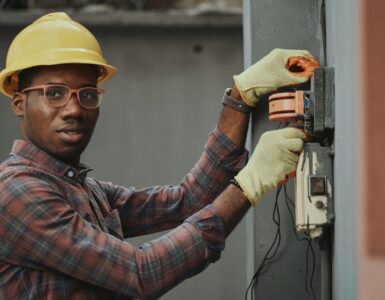 an electrician repairing a fuse box