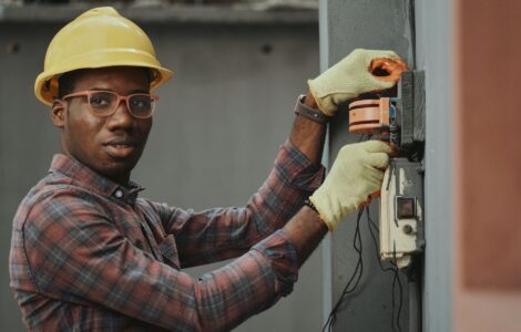 an electrician repairing a fuse box