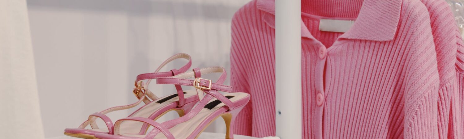 pink sandals beside a pink cardigan