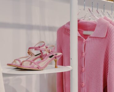 pink sandals beside a pink cardigan